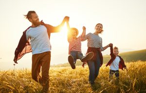 Banca Cambiano Happy family: mother, father, children son and daughter on sunset